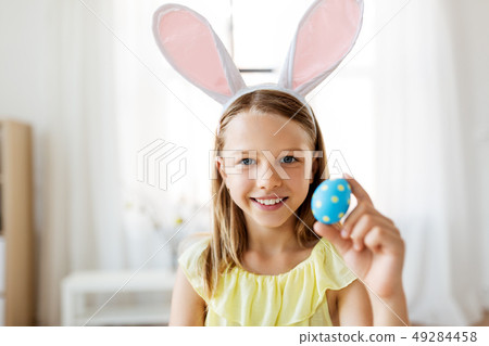 happy girl with colored easter egg at home happy girl with colored easter egg at home 49284458