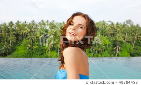 happy woman over infinity edge pool in sri lanka happy woman over infinity edge pool in sri lanka 49284459