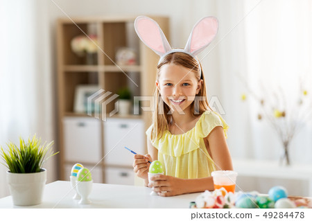 happy girl coloring easter eggs at home happy girl coloring easter eggs at home 49284478