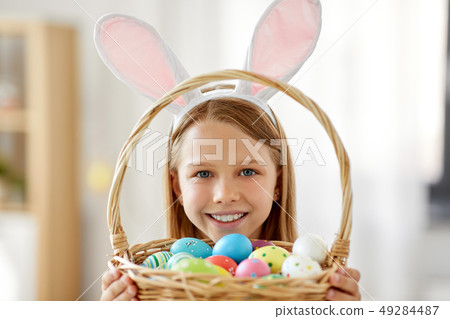 happy girl with colored easter eggs at home happy girl with colored easter eggs at home 49284487