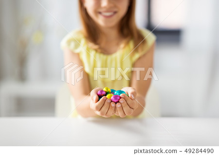 close up of girl holding chocolate easter eggs close up of girl holding chocolate easter eggs 49284490