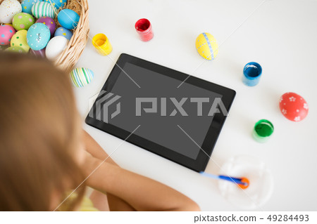 girl with tablet computer, easter eggs and colors girl with tablet computer, easter eggs and colors 49284493
