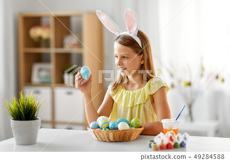 happy girl with colored easter eggs at home happy girl with colored easter eggs at home 49284588