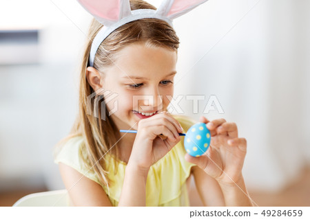 happy girl coloring easter eggs at home happy girl coloring easter eggs at home 49284659