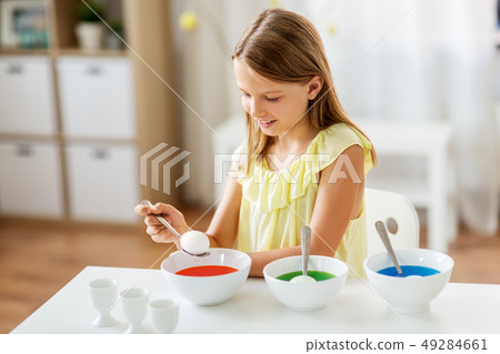girl coloring easter eggs by liquid dye at home girl coloring easter eggs by liquid dye at home 49284661