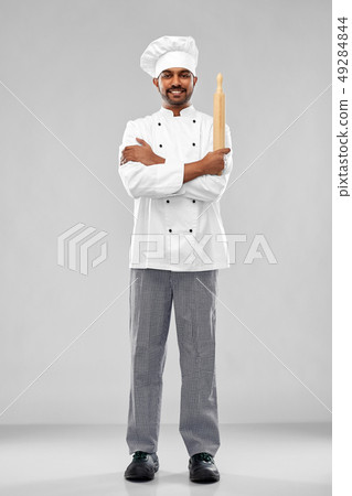 happy male indian chef or baker with rolling-pin happy male indian chef or baker with rolling-pin 49284844
