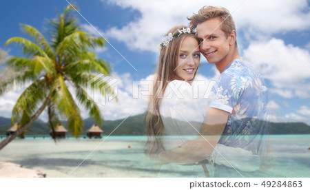 hippie couple fading over exotic beach background 49284863