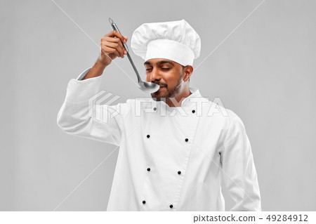 happy male indian chef tasting food from ladle 49284912