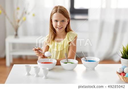 girl coloring easter eggs by liquid dye at home girl coloring easter eggs by liquid dye at home 49285042