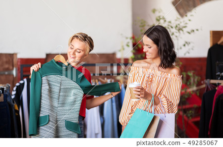 women choosing clothes at vintage clothing store women choosing clothes at vintage clothing store 49285067