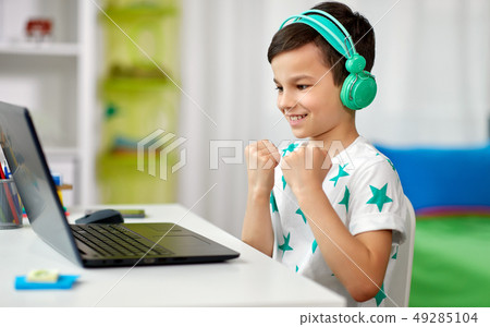 boy celebrating victory in computer video game 49285104
