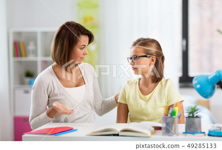 upset mother talking to daughter doing homework upset mother talking to daughter doing homework 49285133