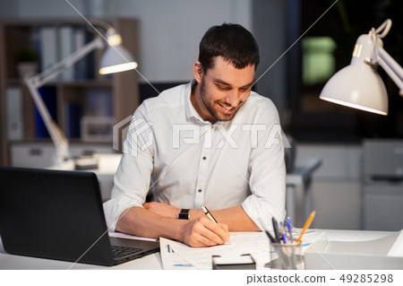 businessman with papers working at night office 49285298
