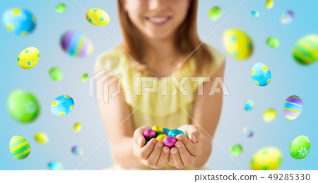 close up of girl holding chocolate easter eggs close up of girl holding chocolate easter eggs 49285330