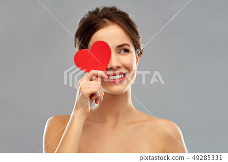 beautiful smiling woman holding red heart 49285331