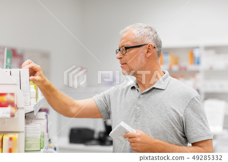 senior male customer with drug at pharmacy senior male customer with drug at pharmacy 49285332