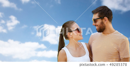 happy couple in sunglasses outdoors in summer happy couple in sunglasses outdoors in summer 49285378