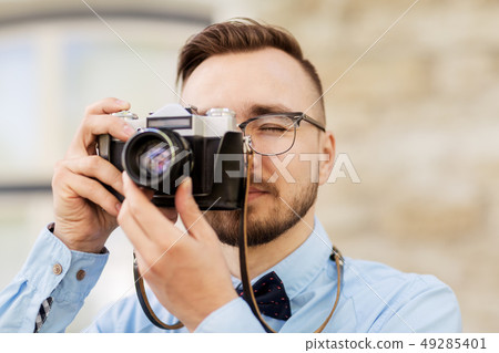 photographer or hipster with film camera outdoors 49285401