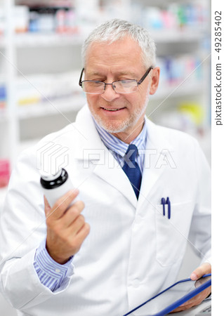 senior with tablet pc at pharmacy senior with tablet pc at pharmacy 49285402