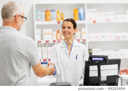 apothecary taking customer credit card at pharmacy apothecary taking customer credit card at pharmacy 49285404