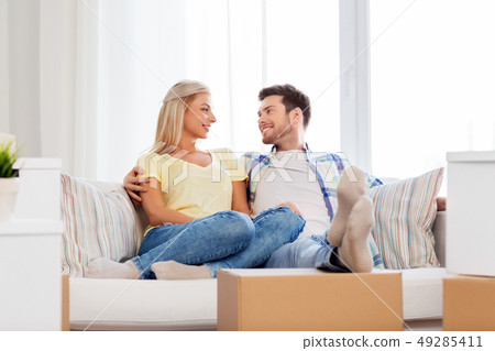 happy couple with boxes moving to new home happy couple with boxes moving to new home 49285411