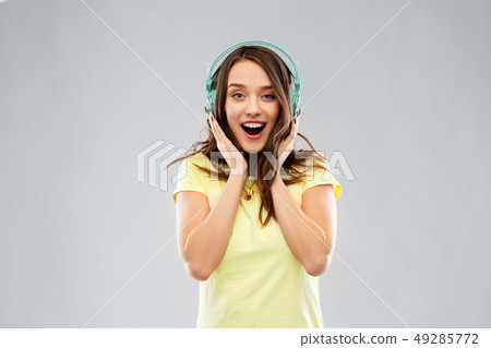 happy young woman or teenage girl with headphones 49285772