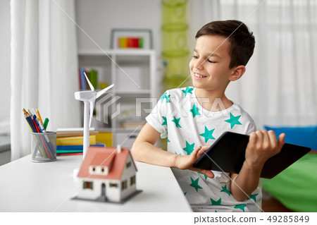 boy with tablet, toy house and wind turbine 49285849