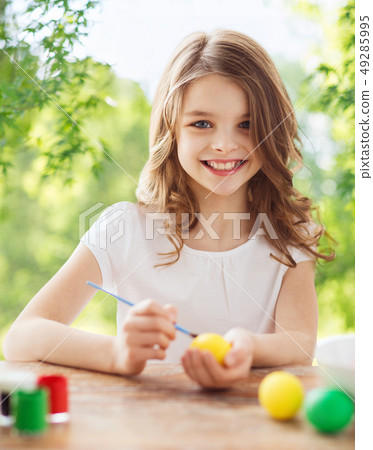 happy smiling girl coloring easter eggs happy smiling girl coloring easter eggs 49285995