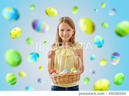 happy girl with colored eggs in wicker basket happy girl with colored eggs in wicker basket 49286004