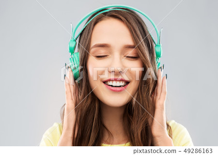 happy young woman or teenage girl with headphones happy young woman or teenage girl with headphones 49286163