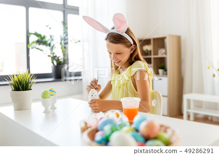 happy girl coloring easter eggs at home happy girl coloring easter eggs at home 49286291