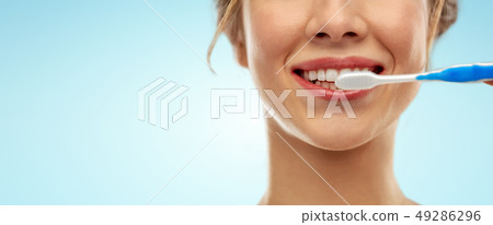close up of woman with toothbrush cleaning teeth close up of woman with toothbrush cleaning teeth 49286296