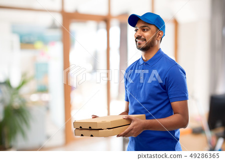 indian delivery man with takeaway pizza at office indian delivery man with takeaway pizza at office 49286365