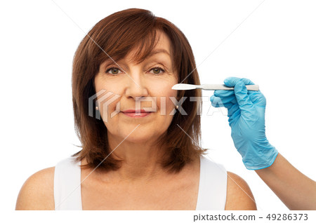 senior woman and surgeon hands with scalpel senior woman and surgeon hands with scalpel 49286373