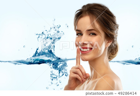 beautiful smiling woman making hush gesture beautiful smiling woman making hush gesture 49286414