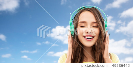happy young woman or teenage girl with headphones happy young woman or teenage girl with headphones 49286443