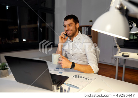 businessman calling on smartphone at night office businessman calling on smartphone at night office 49286447