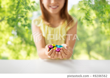 close up of girl holding chocolate easter eggs close up of girl holding chocolate easter eggs 49286562