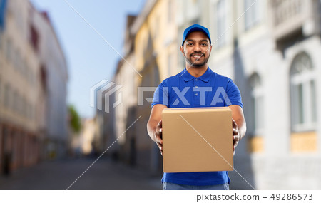 happy indian delivery man with parcel box in city happy indian delivery man with parcel box in city 49286573