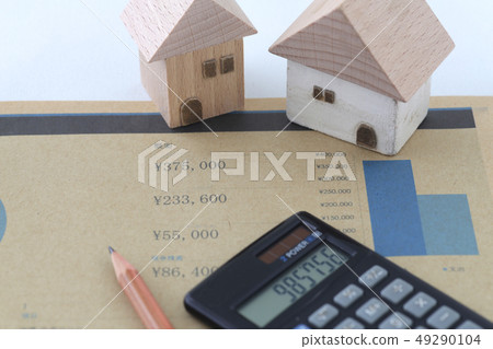 Line graph written on paper and house model with money and pencil and calculator Line graph written on paper and house model with money and pencil and calculator 49290104