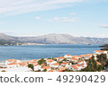 Korcula island with red roof houses and mountains and sky 49290429