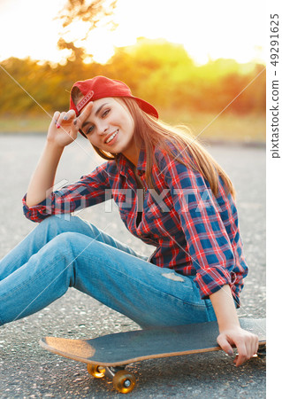 Cheerful girl in a shirt and a baseball cap  49291625