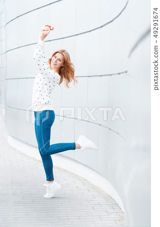 Beautiful girl with a smile in a white sweater Beautiful girl with a smile in a white sweater 49291674