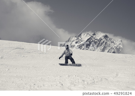 Snowboarder downhill on ski slope in high snowy Snowboarder downhill on ski slope in high snowy 49291824