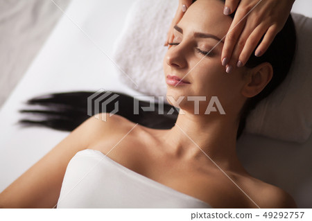Face Massage. Close-up of a Young Woman Getting Spa Treatment. 49292757