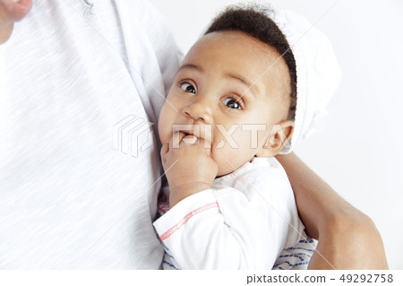 Portrait of beautiful african woman holding on hands her little baby 49292758