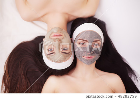 Two girls are relaxing during facial mask application in spa 49292759