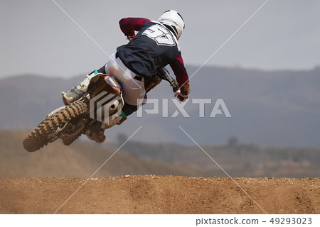 Rider driving in the motocross race Rider driving in the motocross race 49293023