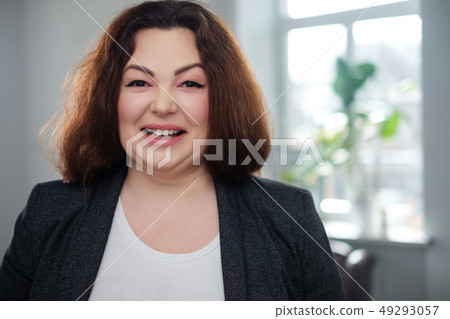 Portrait of a cheerful plus size model 49293057
