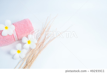 Rolled pink spa towel and .Frangipani flowers  49293911